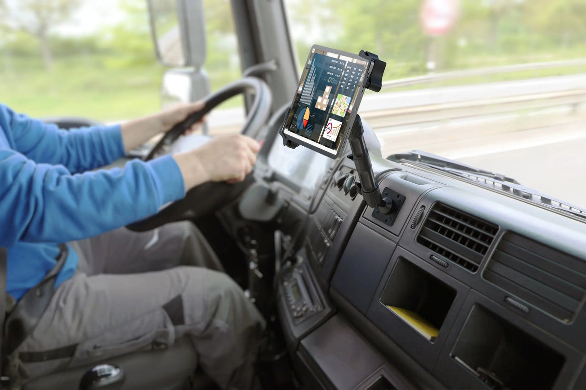 Driver with a tablet on a dash mount in a truck cab